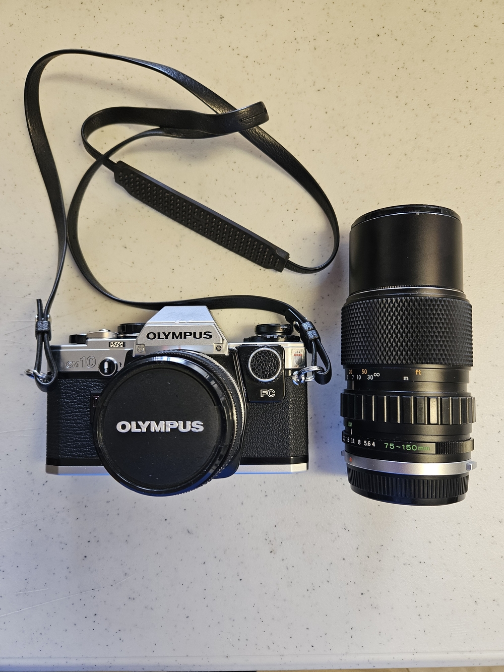 Olympus OM-10Olympus OM-10 35mm Film Camera with 75-150mm Telephoto Lens - Black